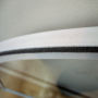 Picture of the curved edge of a fixed unit of secondary glazing.